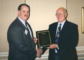 Rick DeBowes presenting award to Jack Judy